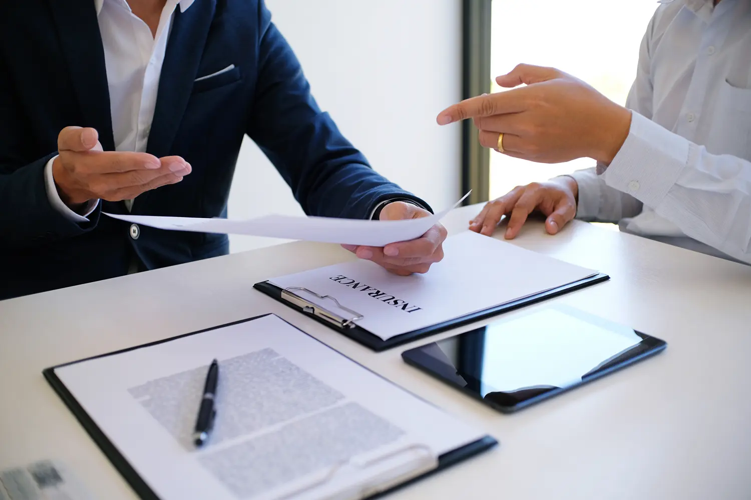 Sales manager giving advice application form document, considering mortgage loan offer for car and house insurance